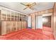 Bedroom with wood-paneled walls, a wall mirror, and a vintage ceiling fan at 1810 N 74Th St, Scottsdale, AZ 85257