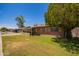 Well-maintained home with mature trees and partial brick exterior, set on a green lawn at 1810 N 74Th St, Scottsdale, AZ 85257