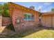 Exterior view of brick building shows a window and utility components at 1810 N 74Th St, Scottsdale, AZ 85257
