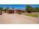 Single-Gathering home with attached carport and desert landscaping on a sunny day at 1810 N 74Th St, Scottsdale, AZ 85257