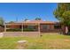 Charming brick home with a covered front porch and a well-maintained lawn at 1810 N 74Th St, Scottsdale, AZ 85257