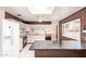 A retro kitchen with pastel cabinets, marbled countertops, wood paneling, and stainless steel appliances at 1810 N 74Th St, Scottsdale, AZ 85257