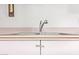 This kitchen sink features a stainless steel faucet with pastel cabinets and marble countertops at 1810 N 74Th St, Scottsdale, AZ 85257