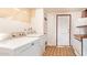 This laundry room features a washing machine and dryer, along with some shelving for extra storage at 1810 N 74Th St, Scottsdale, AZ 85257
