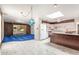 Bright living room with a kitchen island and white and wood toned cabinets at 1810 N 74Th St, Scottsdale, AZ 85257