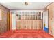 Spacious living room features paneled walls, retro orange carpet and brick accents at 1810 N 74Th St, Scottsdale, AZ 85257