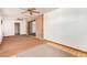 Spacious living room featuring both carpet and tile flooring, a ceiling fan, and sliding glass doors at 1810 N 74Th St, Scottsdale, AZ 85257