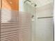 Bathroom shower with textured glass enclosure, tiled walls, and chrome fixtures at 1810 N 74Th St, Scottsdale, AZ 85257