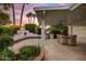 Covered patio, outdoor kitchen and fireplace create a relaxing backyard retreat at 1831 E Rovey Ave, Phoenix, AZ 85016