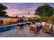 Beautiful backyard oasis with a pool, fire pit, and comfortable seating area at 1831 E Rovey Ave, Phoenix, AZ 85016