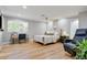 Well-lit bedroom featuring neutral colors, light hardwood floors, and a ceiling fan at 1831 E Rovey Ave, Phoenix, AZ 85016