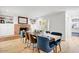 Cozy dining area with fireplace, built-in shelving, and wood table with upholstered chairs at 1831 E Rovey Ave, Phoenix, AZ 85016