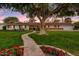 Charming single-story home with lush lawn, brick walkway, and mature shade tree at 1831 E Rovey Ave, Phoenix, AZ 85016