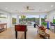 Bright game room featuring foosball table, opens to the pool, with backyard views at 1831 E Rovey Ave, Phoenix, AZ 85016