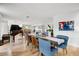 Open living space with wood floors, piano and view to kitchen, dining room at 1831 E Rovey Ave, Phoenix, AZ 85016