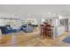Open-concept living area with hardwood floors, modern furniture, and abundant natural light at 1831 E Rovey Ave, Phoenix, AZ 85016