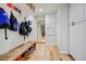 Inviting mudroom with a wood bench, bag storage, and hardwood floors at 1831 E Rovey Ave, Phoenix, AZ 85016