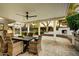 Inviting outdoor living space features a covered patio, fireplace, and comfortable seating, perfect for entertaining at 1831 E Rovey Ave, Phoenix, AZ 85016