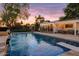 Sparkling pool with a diving board, waterfall feature, and serene backyard setting at 1831 E Rovey Ave, Phoenix, AZ 85016