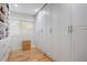 Spacious walk-in closet featuring custom storage solutions and hardwood floors at 1831 E Rovey Ave, Phoenix, AZ 85016