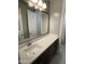 Bathroom features a white countertop, a undermount sink, and a large mirror reflecting a white door at 1840 S Follett Way, Gilbert, AZ 85295