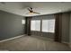 This bedroom is spacious and includes a ceiling fan, neutral colors, and natural lighting at 1840 S Follett Way, Gilbert, AZ 85295