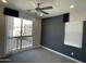 Bedroom with a large window overlooking a green space, accompanied by a modern ceiling fan at 1840 S Follett Way, Gilbert, AZ 85295