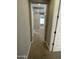 Hallway with neutral carpet and wall colors, leading to a room with bright natural light at 1840 S Follett Way, Gilbert, AZ 85295