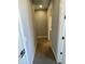Hallway with neutral-colored walls, plush carpet, and white trim, leading to multiple rooms at 1840 S Follett Way, Gilbert, AZ 85295