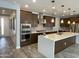 A kitchen with stainless steel appliances, dark brown cabinetry, and a large white island at 1840 S Follett Way, Gilbert, AZ 85295