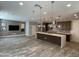 Open-concept kitchen and living room area with modern pendant lighting and stainless steel appliances at 1840 S Follett Way, Gilbert, AZ 85295