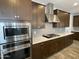 Modern kitchen with stainless steel appliances, attractive tile backsplash, and wooden cabinetry at 1840 S Follett Way, Gilbert, AZ 85295