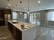 Open-concept living room featuring a large island, recessed lighting, and sliding glass doors at 1840 S Follett Way, Gilbert, AZ 85295