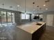 Open living space with an island, patio access, and decorative lighting fixtures at 1840 S Follett Way, Gilbert, AZ 85295
