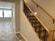 A staircase featuring carpeted steps, a wooden railing, and black metal balusters at 1840 S Follett Way, Gilbert, AZ 85295