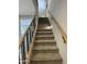 Carpeted staircase with wooden handrails and modern black balusters at 1840 S Follett Way, Gilbert, AZ 85295