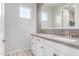 Bathroom featuring a white vanity with stone countertop and a large mirror with accent tile at 1848 S Follett Way, Gilbert, AZ 85295