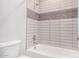 Bathroom showcasing tiled walls and a tub and shower combination at 1848 S Follett Way, Gilbert, AZ 85295