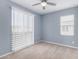 Bedroom featuring carpet floors, ceiling fan, and natural light from a sliding glass door and window at 1848 S Follett Way, Gilbert, AZ 85295