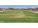 Beautifully landscaped community lawn with lush green grass and well-maintained walking paths, perfect for outdoor activities at 1848 S Follett Way, Gilbert, AZ 85295