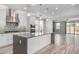 Kitchen boasts a central island, stainless appliances, designer backsplash, and plenty of natural light at 1848 S Follett Way, Gilbert, AZ 85295