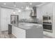 Modern kitchen with stainless steel appliances, large island and mosaic tile backsplash at 1848 S Follett Way, Gilbert, AZ 85295