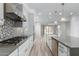 Open concept kitchen with white cabinets, stainless steel appliances, and a center island at 1848 S Follett Way, Gilbert, AZ 85295