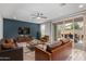 Inviting living room with leather furniture, stylish rug, and seamless access to outdoor patio at 1848 S Follett Way, Gilbert, AZ 85295