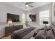 Relaxing main bedroom with large TV, stylish dresser, and light-filled windows at 1848 S Follett Way, Gilbert, AZ 85295