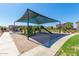 Well-maintained community playground with covered play structures, offering a safe and fun environment for children at 1848 S Follett Way, Gilbert, AZ 85295