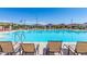 Community swimming pool with lounge chairs and clear blue water, perfect for relaxation at 1848 S Follett Way, Gilbert, AZ 85295
