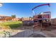 Large backyard with a well-kept lawn, inviting pergola, and privacy fence, perfect for outdoor activities and relaxation at 18581 W College Dr, Goodyear, AZ 85395