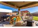 Covered outdoor bar and kitchen area with BBQ at 18581 W College Dr, Goodyear, AZ 85395