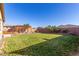 Expansive backyard featuring a lush lawn, mature trees, and a charming pergola area, ideal for outdoor gatherings at 18581 W College Dr, Goodyear, AZ 85395